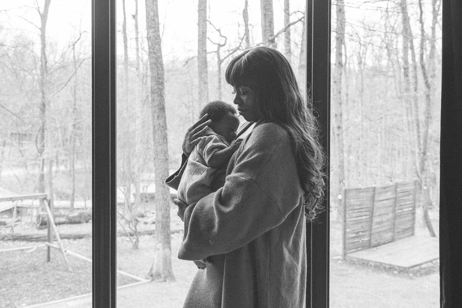 Parent paced bottle feeding a newborn held upright