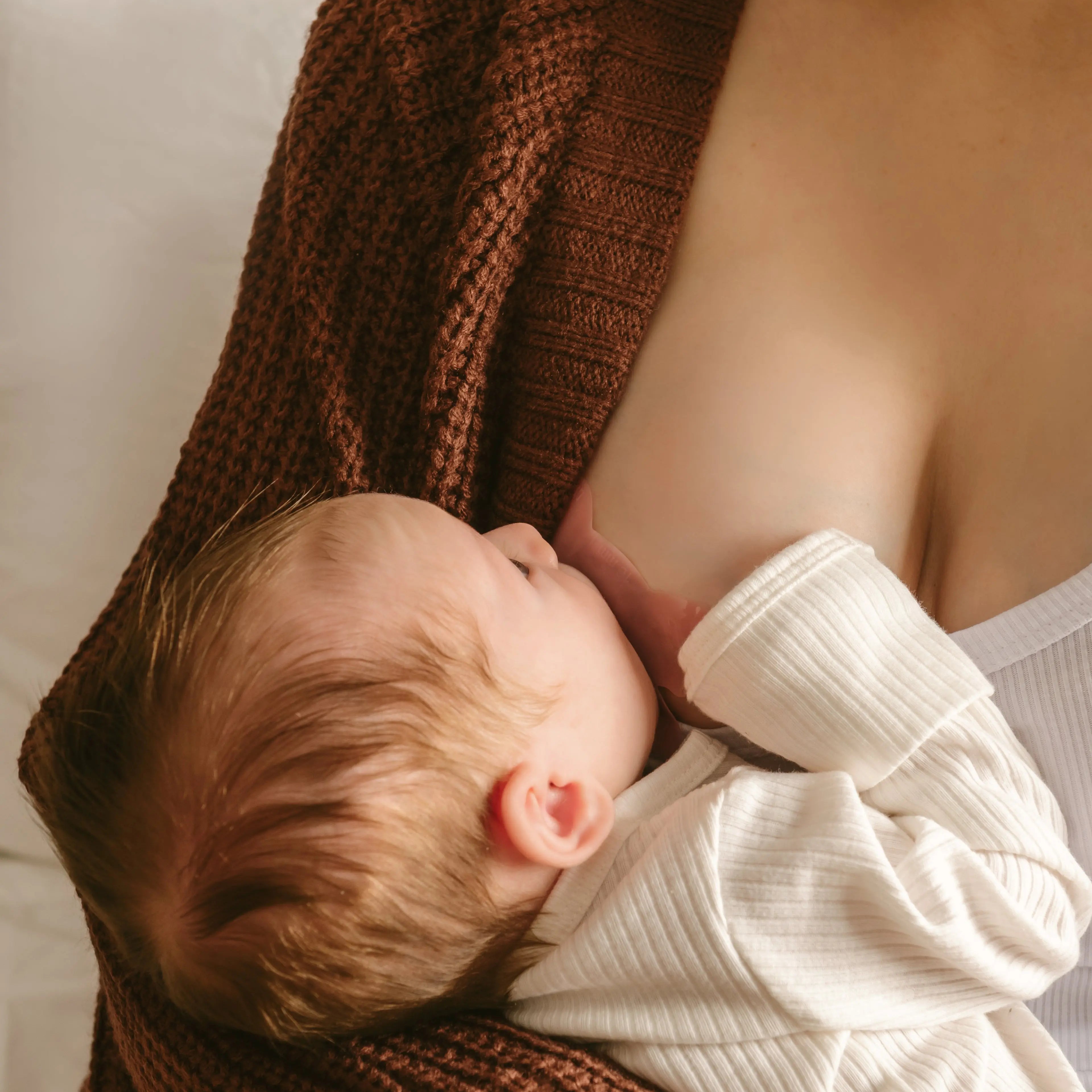 breastfeeding mom using Le Lolo colored nipple shield for improved latch