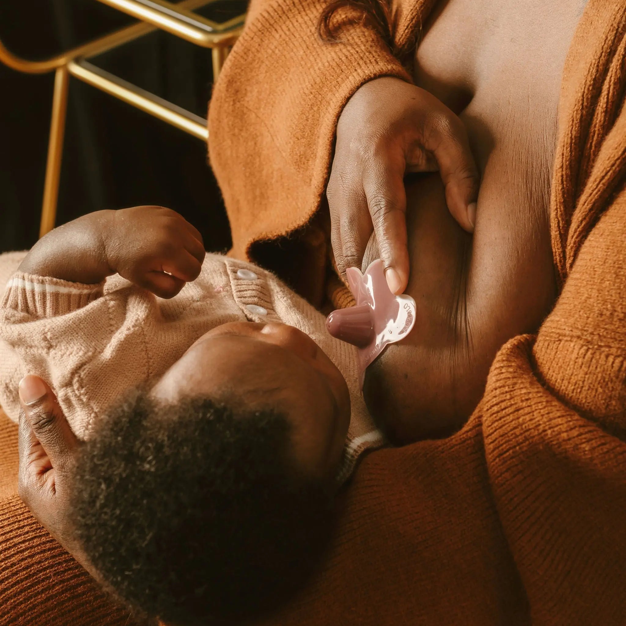 breastfeeding mom using Le Lolo colored nipple shield for improved latch