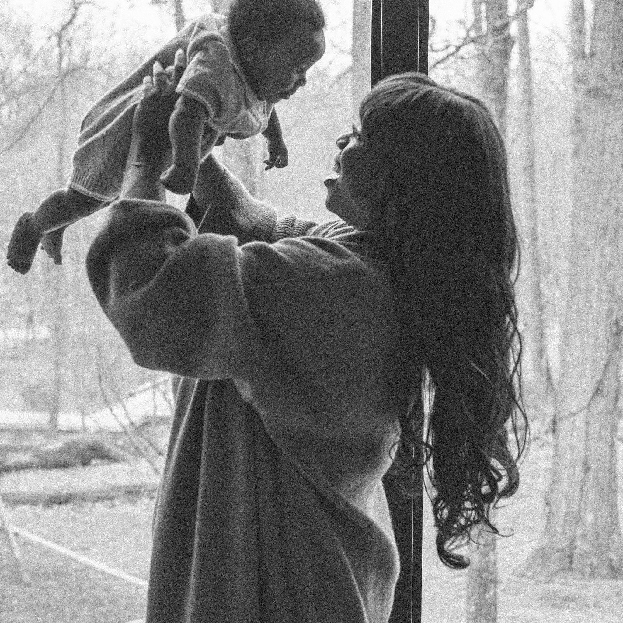 postpartum mom holding new baby