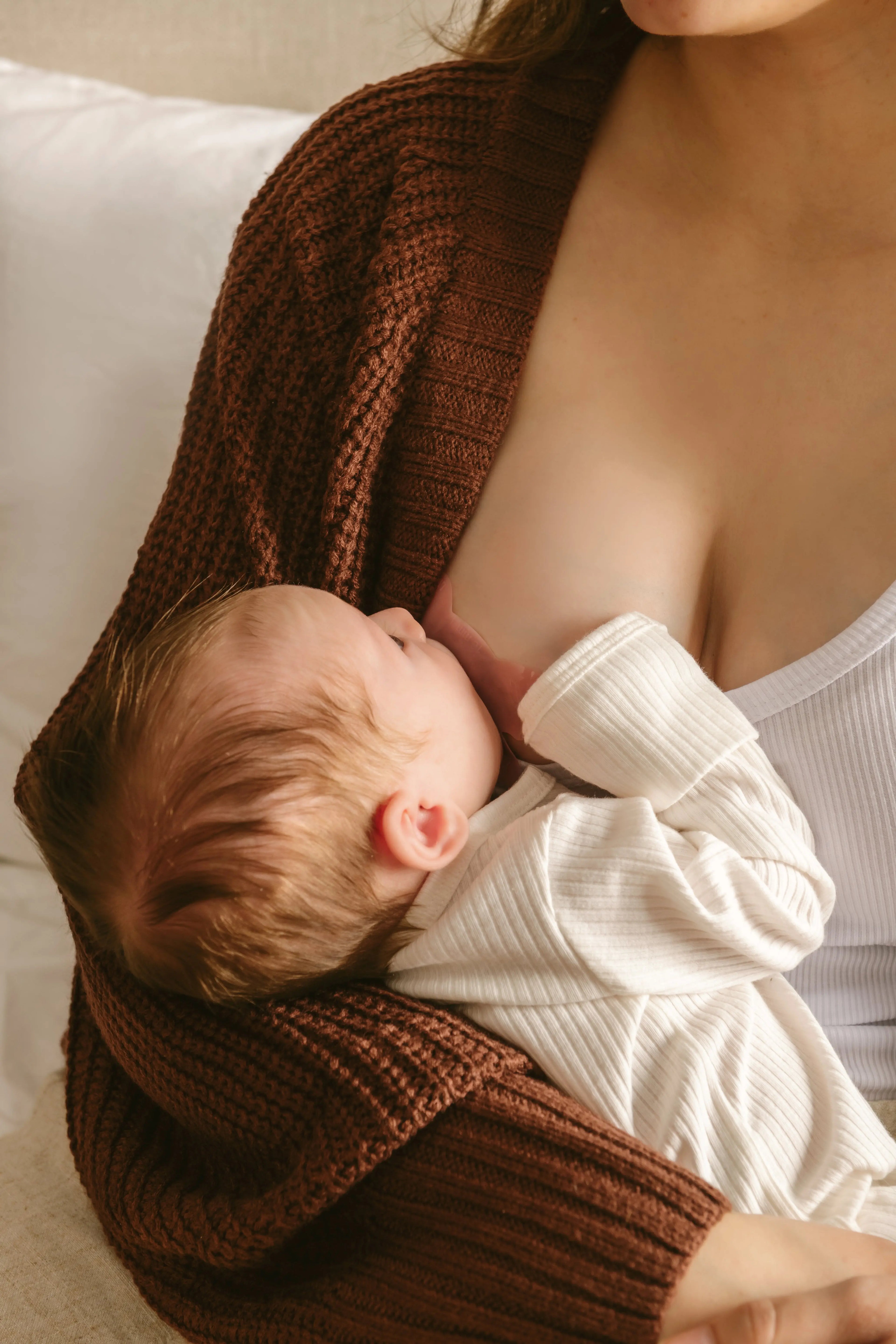 breastfeeding mom using Le Lolo colored nipple shield for improved latch
