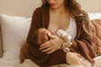 postpartum mom after birth breastfeeding newborn baby