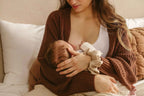 postpartum mom after birth breastfeeding newborn baby