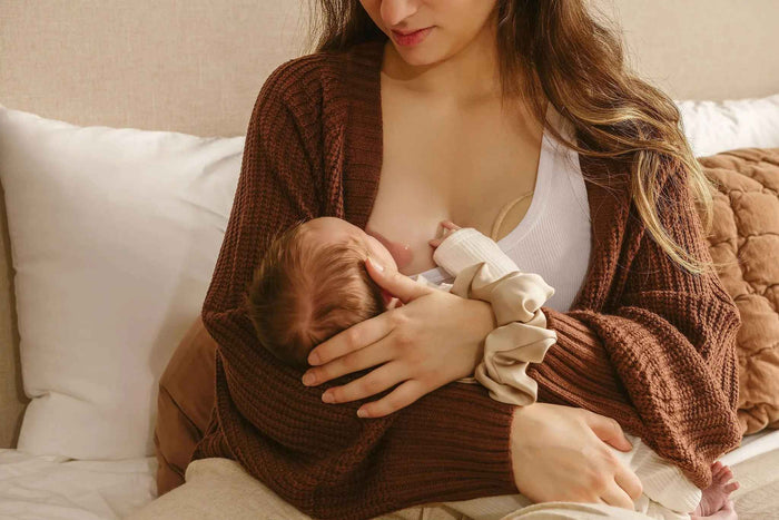 postpartum mom after birth breastfeeding newborn baby