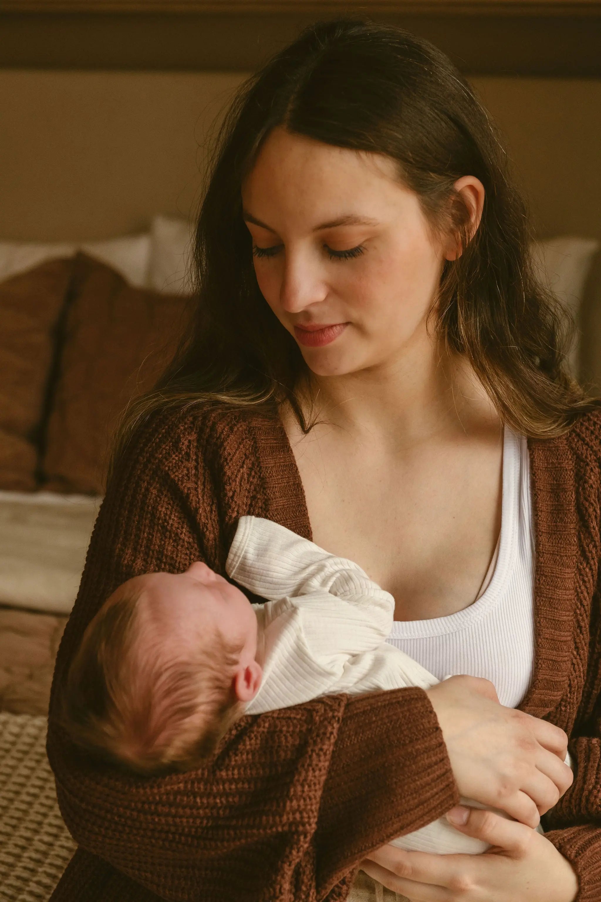 nursing mom holding new baby