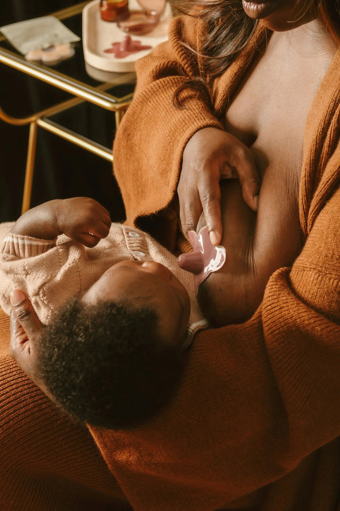 breastfeeding mom using Le Lolo colored nipple shield for improved latch