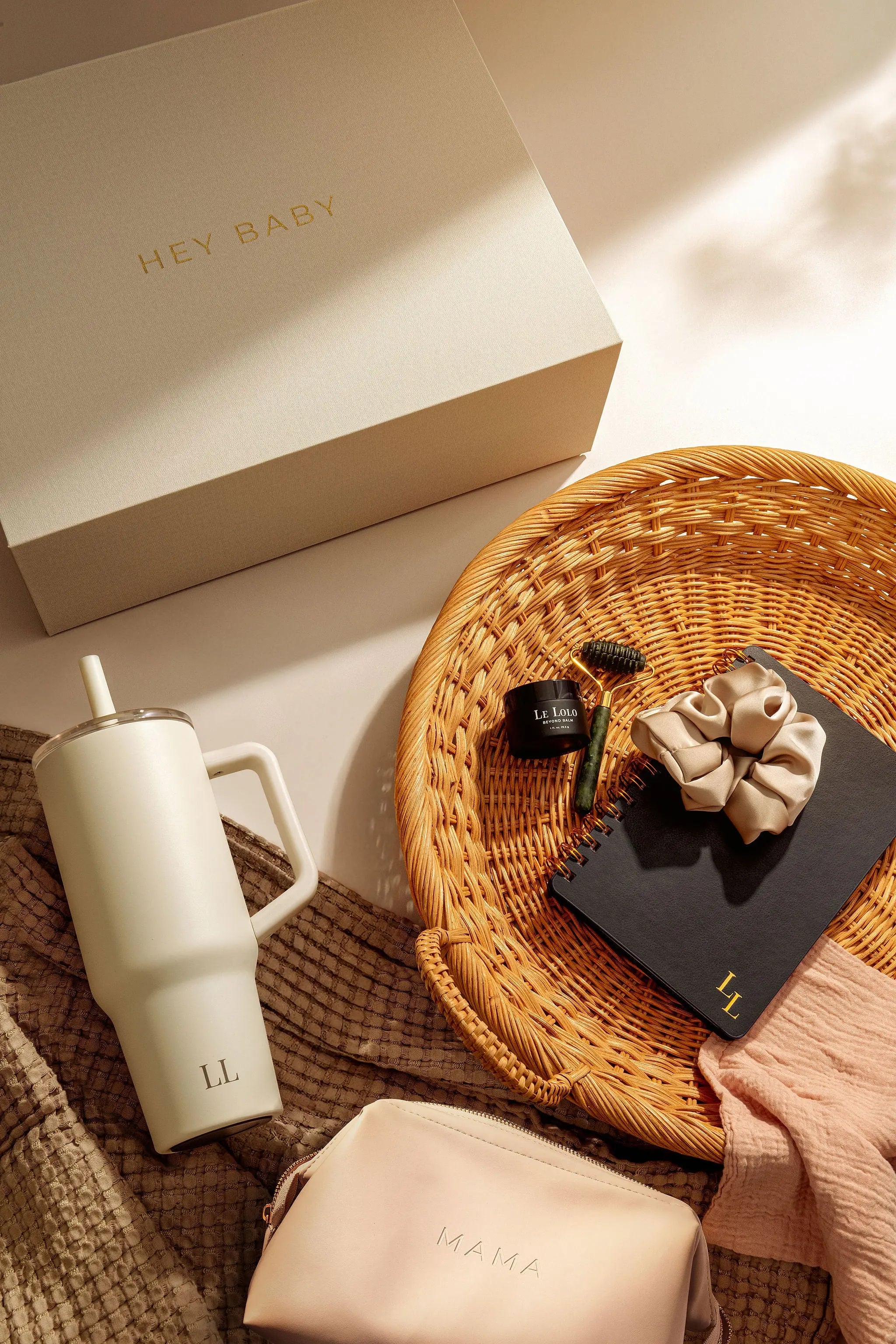 baby shower gift set for expecting mom including vegan leather bag, water bottle, hair scrunchie, postpartum journal, jade roller for massage and organic healing cream