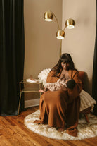 breastfeeding mom using colored nipple cover with a small clamshell case for breastfeeding nipple shields