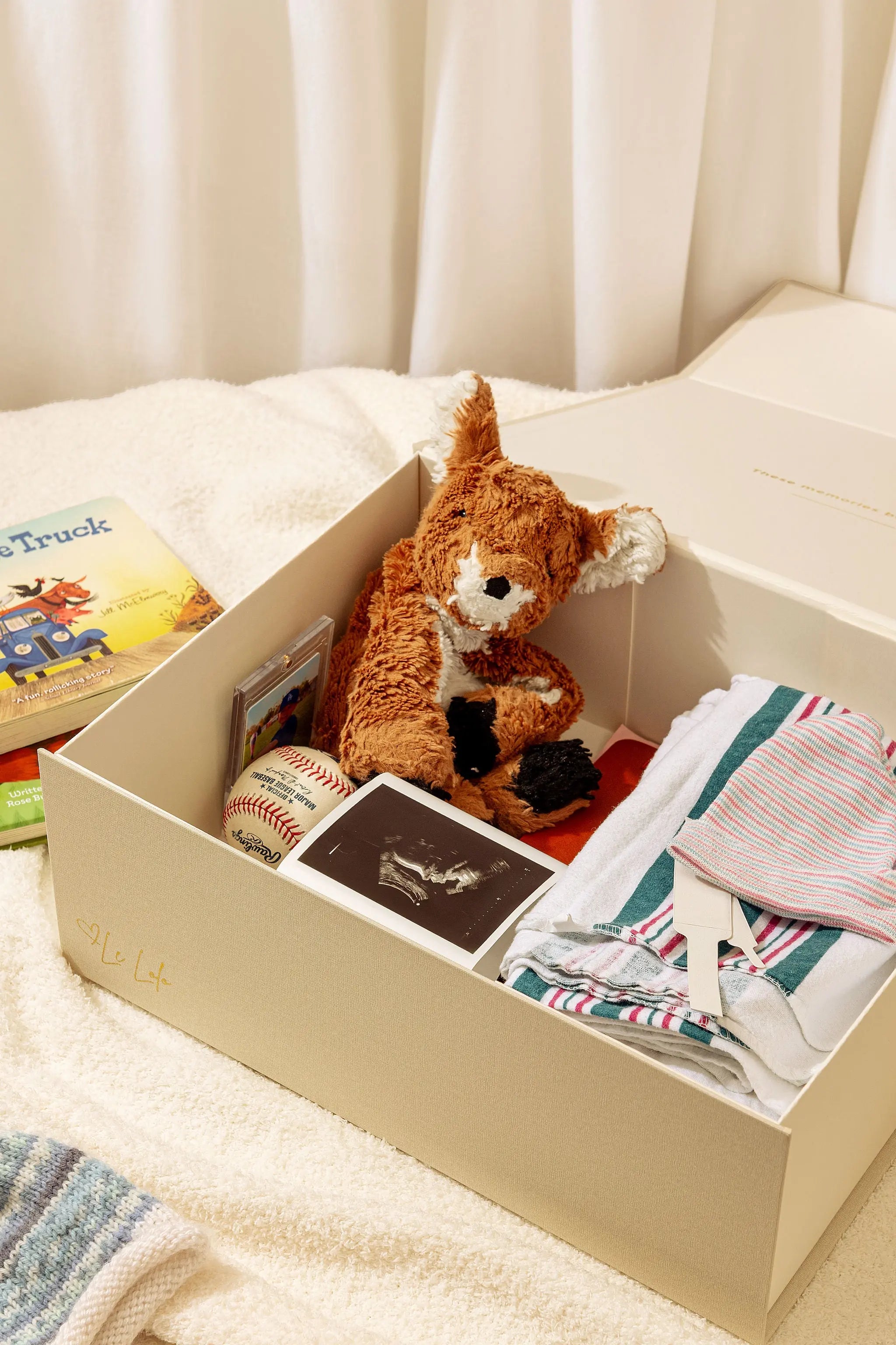 Baby keepsake box for storing first outfits and photos